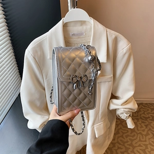 Silver quilted crossbody phone bag with bow clasp and metallic chain strap for women