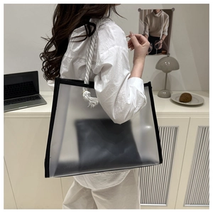 Detail of translucent frosted PVC tote bag with black trim and white cotton rope handles
