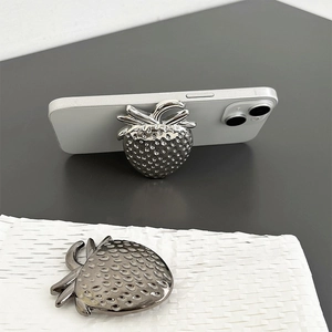 Metallic strawberry phone grip holder in gunmetal grey finish on a white surface