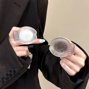 Detailed macro view of two fish-shaped matte grip holders in grey and white tones