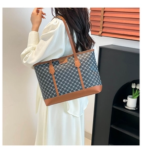 Close-up of vintage tote bag with geometric pattern and long leather shoulder straps