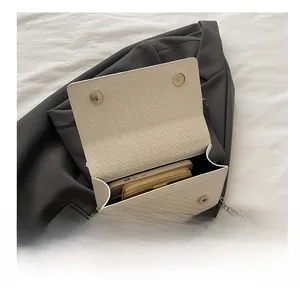 Interior view of the houndstooth chain bag showing storage capacity for phone and wallet