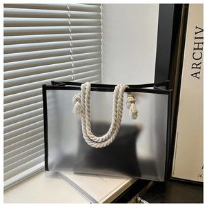 Detail of translucent frosted tote bag with black piping and thick white rope handle