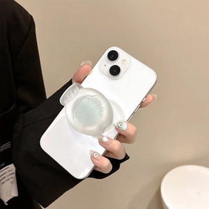 Detail of translucent green frosted fish-shaped Griptok on a white smartphone