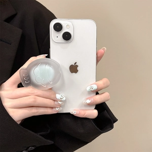 Frosted matte fish-shaped phone grip stand in green held against a white smartphone