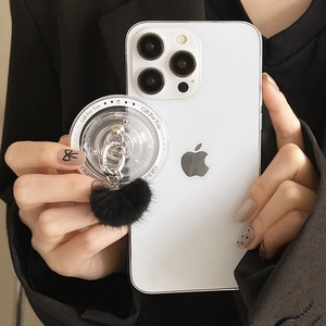 Detail of luxury acrylic phone socket with black faux fur ball and silver ring grip