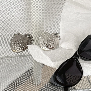 Close-up of silver metal strawberry phone socket with realistic texture on white paper