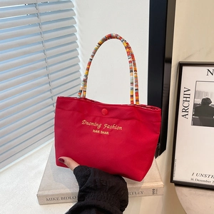 Red canvas handbag with embroidered letters and colorful bohemian beaded handle