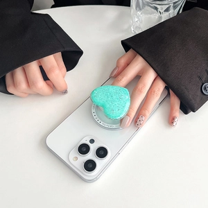 Macro view of mint green glitter heart popsocket with Gift For You text on phone