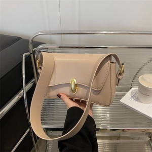 Beige Ledertasche mit goldenem Ovalverschluss und breitem Riemen für den Alltag im Büro