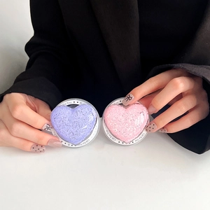 Macro detail of glitter heart phone socket stand in pink and purple colors