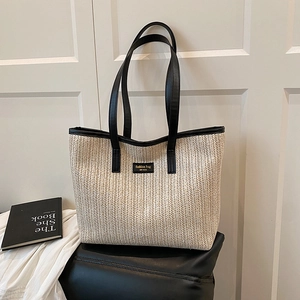 Large capacity straw tote bag with black leather handles and fashion label for summer