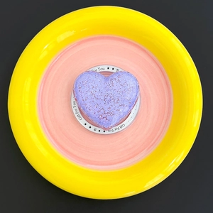 Macro shot of purple heart bath bomb with crystalline texture on Gift For You tray