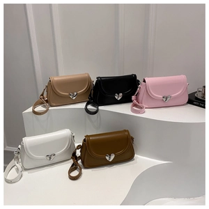 Detailed display of assorted colorful crossbody bags featuring a silver heart-shaped clasp