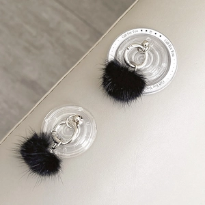 Close-up of a luxury black mink fur phone socket holder with a silver metal ring