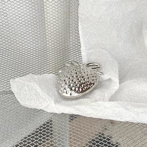 Macro view of metallic strawberry phone grip with realistic seeds and leaf details