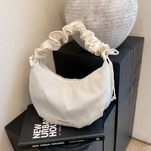 Minimalist cream nylon crescent shoulder bag with a stylish scrunchie handle for summer