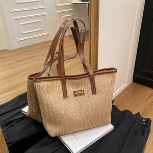 French straw tote bag with brown leather straps and spacious woven design for summer