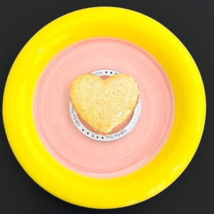 Detail of a heart-shaped glitter phone socket with yellow sequins on a gift base