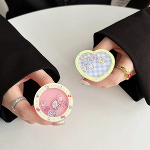 Detailed view of pink round and blue heart glitter phone grips with floating sequins