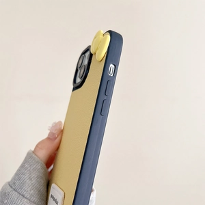 Detail view of the yellow bow and leather texture on a blue iPhone case