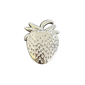 Polished silver metal strawberry-shaped phone socket stand with realistic seed texture