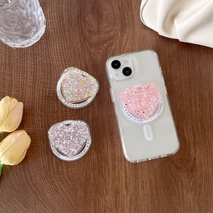 Detail van hartvormige glitter telefoonhouder met Gift For You tekst op de basis