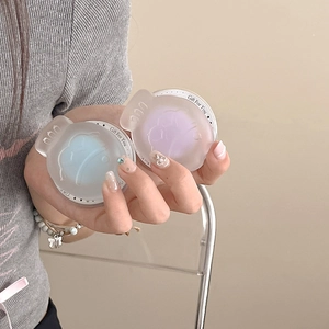 Detailed macro of matte frosted blue and purple round cases with Gift For You engraving