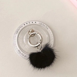 Detail of soft black mink fur phone grip pendant with polished silver spring ring buckle