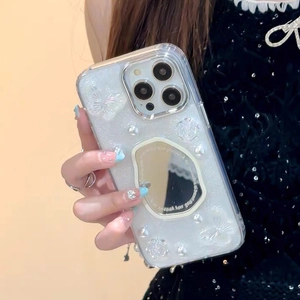 Detail of iPhone glitter case featuring pearl butterfly accents and a built-in makeup mirror