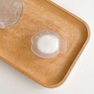 Detailed view of pink fish-shaped phone grip with a frosted translucent matte finish