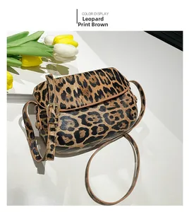 Detail of leopard print saddle bag with gold metal buckle and vintage leather texture