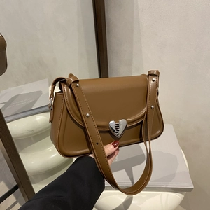 Brown faux leather shoulder bag with a large silver heart-shaped clasp and adjustable strap