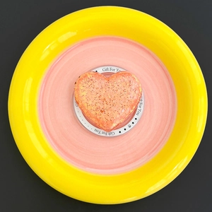 Detail of pink glitter heart-shaped phone grip on a decorative Gift For You white base
