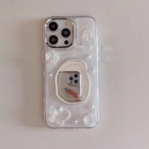 Detail of pearl white iPhone case featuring mirror, 3D butterflies, and floral decorations