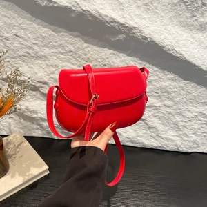 Modern red saddle shoulder bag with matte leather finish and adjustable strap