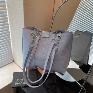 Minimalist light blue canvas tote bag for women with metallic ring details and large capacity