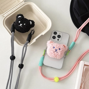 Detail of plush bear phone holders with woven crossbody straps in black and pink