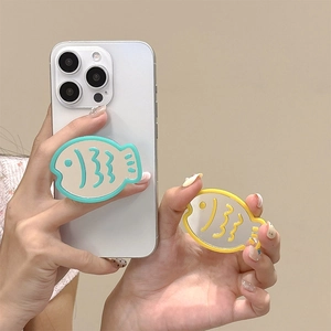 Fish-shaped phone grip with mirror in mint green and yellow on a white mobile phone