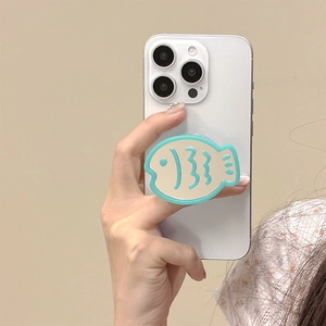 Handheld view of a blue fish-shaped phone grip with a built-in mirror on a smartphone
