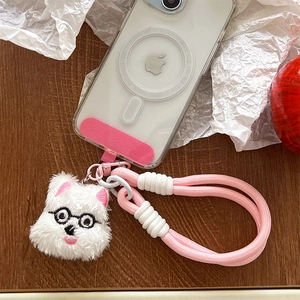Detail of plush puppy charm with pink braided wrist lanyard for phone cases