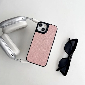 Detail of pink lychee leather phone case for iPhone with stylish sunglasses and headphones