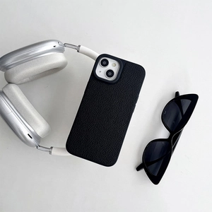 Detail of black lychee leather phone case with camera protection and minimalist design