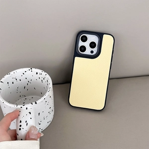 Detail of cream lychee leather iPhone case with black camera frame protection