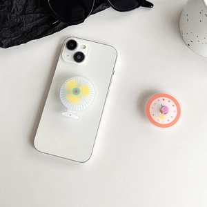 Minimalist rotating fan phone grip stand shown on a white smartphone and desk