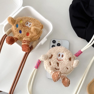 Detail of plush cookie mini crossbody bags with braided straps in brown and cream colors