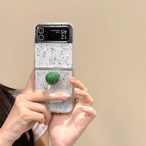 Detail of glitter Z Flip case with green spherical grip and transparent hand strap