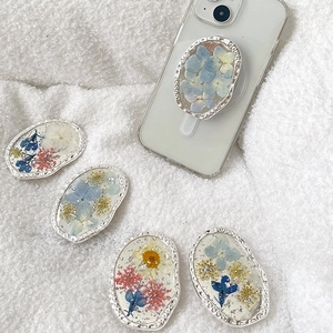 Silver oval floral phone grip with dried flowers and silver foil on white fabric