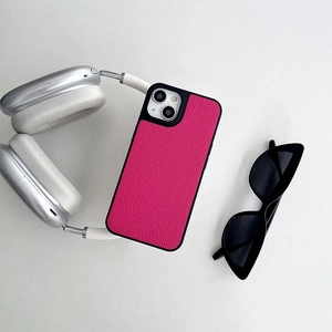 Magenta litchi texture leather phone case styled with headphones and sunglasses