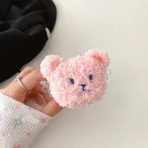 Detailed close-up of a pink plush bear earphone case with soft fur and blue embroidery